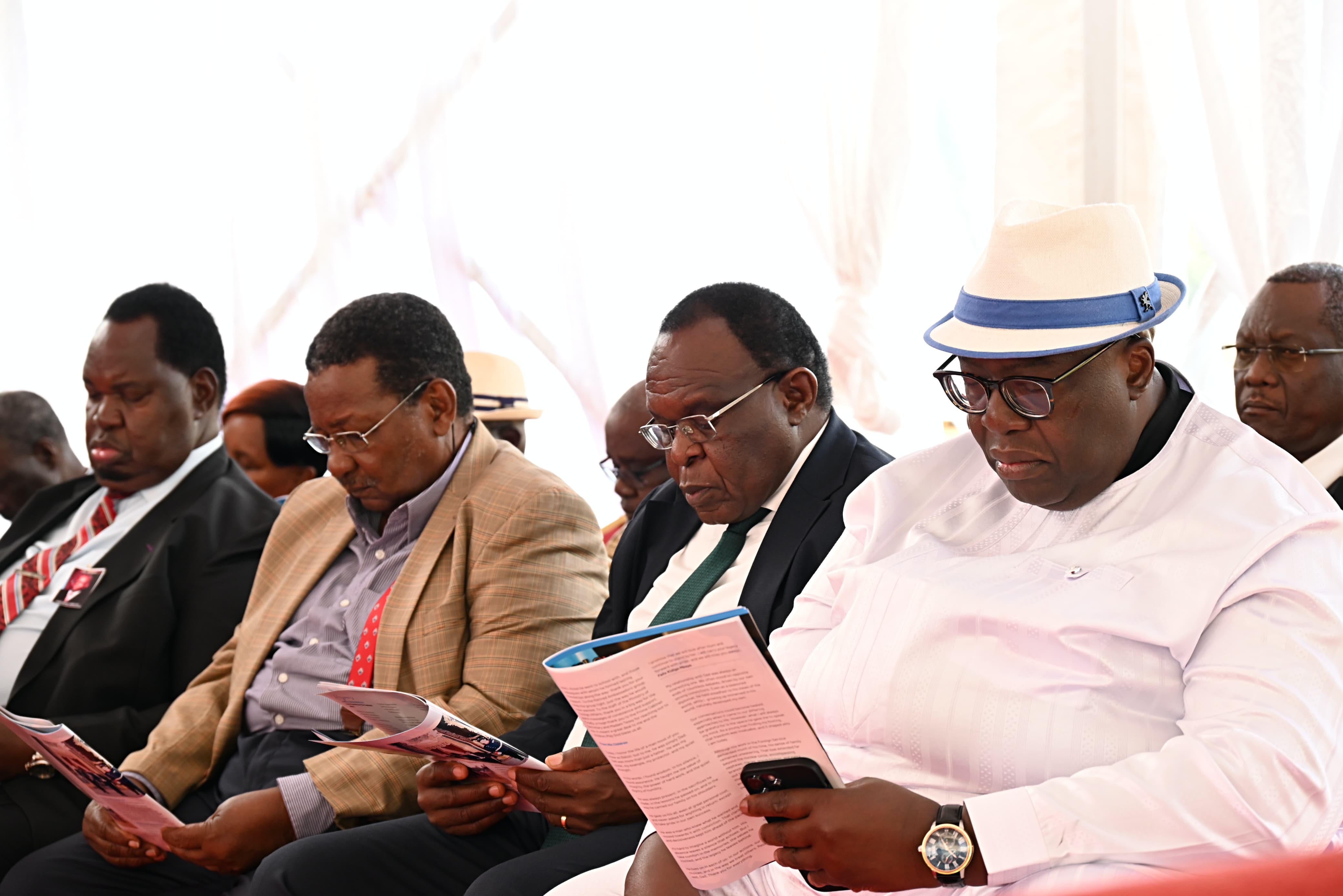 Former ambassadors follow the funeral program during the final send-off of Ambassador Mbaya in Vihiga County.