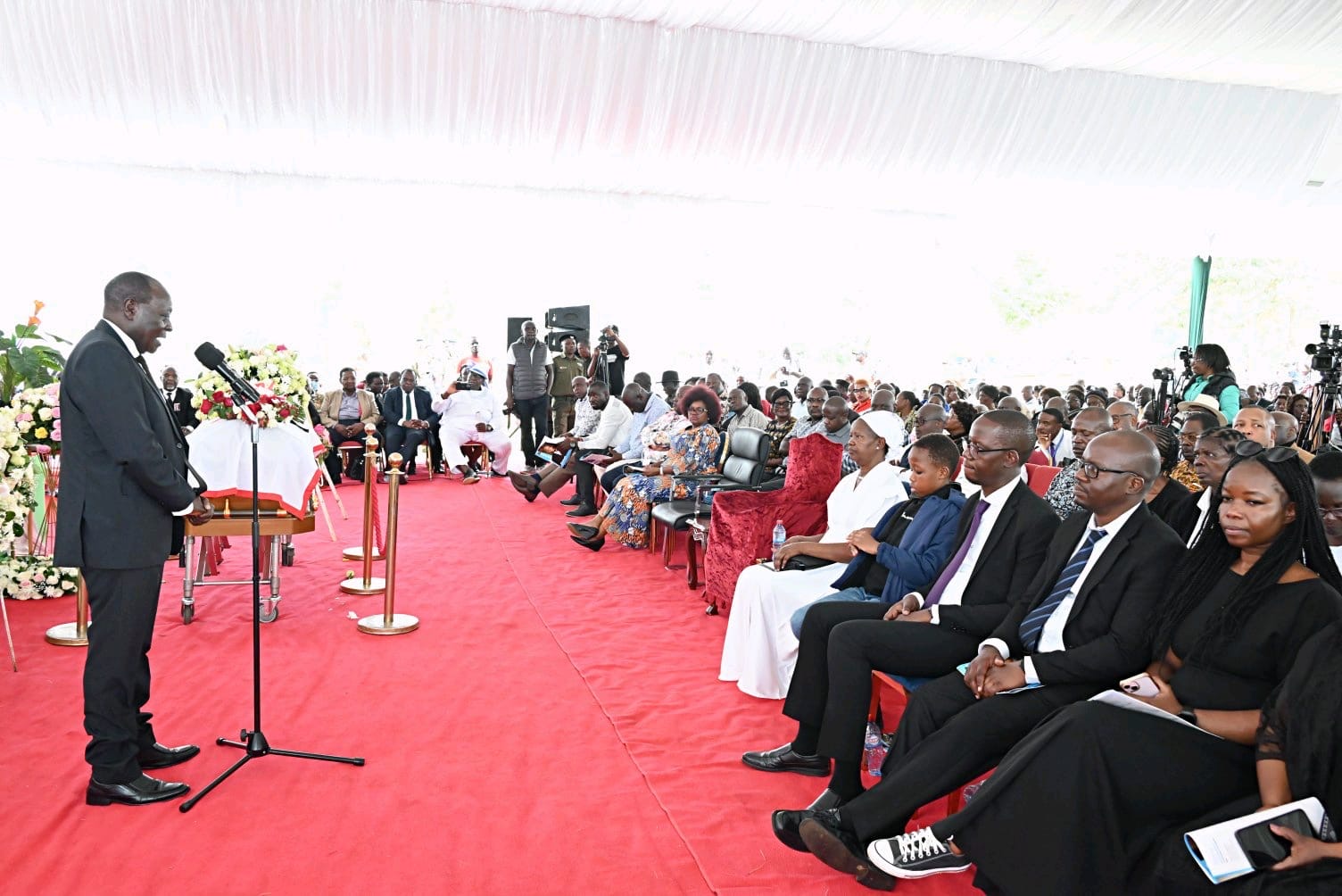 Vihiga County Governor Dr. Wilber Ottichilo addresses mourners during Amb. Mbaya's funeral
